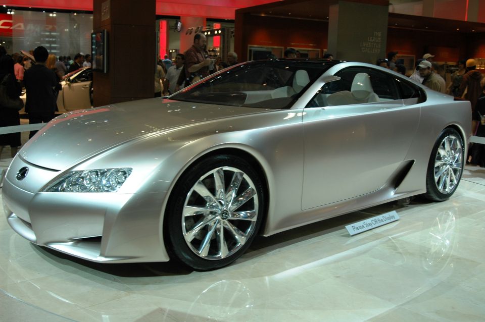 Silver concept car with lines and chrome wheels on display