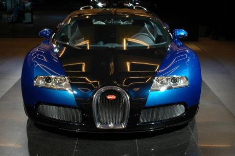 1991 Ford Taurus - A blue and black Bugatti Veyron is displayed from the front, with its distinctive grille and headlights visible.