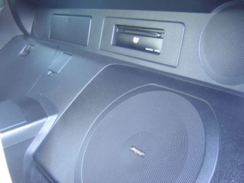 2004 Nissan 350Z - Interior shot of a car's dashboard a DVD player and speaker system.