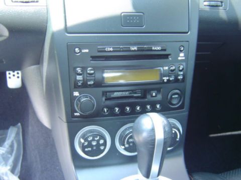 2004 Nissan 350Z - The interior of a 2004 Nissan 350Z shows its Bose audio system and climate controls.