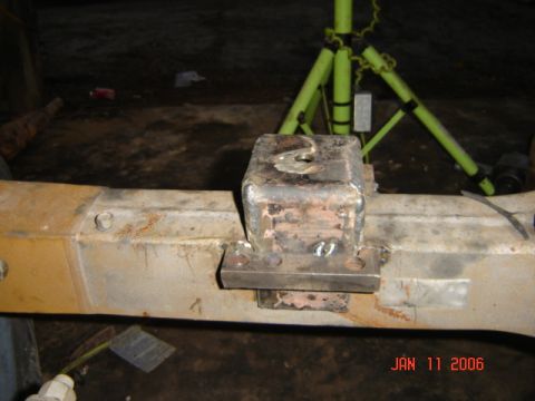 1982 Nissan Titan - A close-up view of a welded metal bracket on a vehicle's frame, with visible rust and rust.