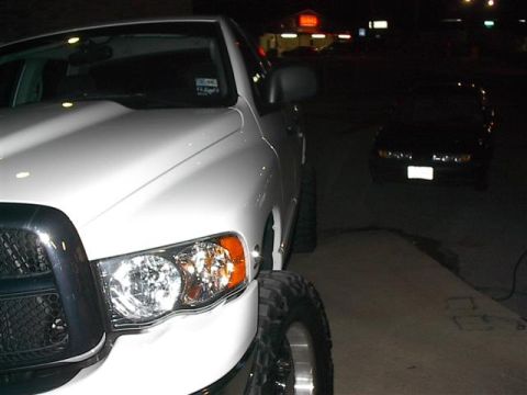 2001 Dodge 1500 - A white pickup truck is parked at night, with another vehicle in the background.