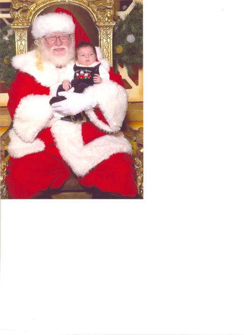 2002 Ford Taurus - Santa Claus poses for a photo with a baby.