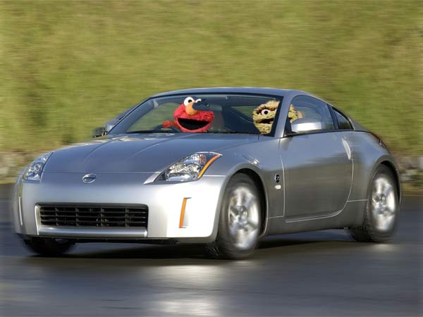 Silver Nissan 350Z coupe rolling shot with Elmo and Cookie Monster photoshopped inside