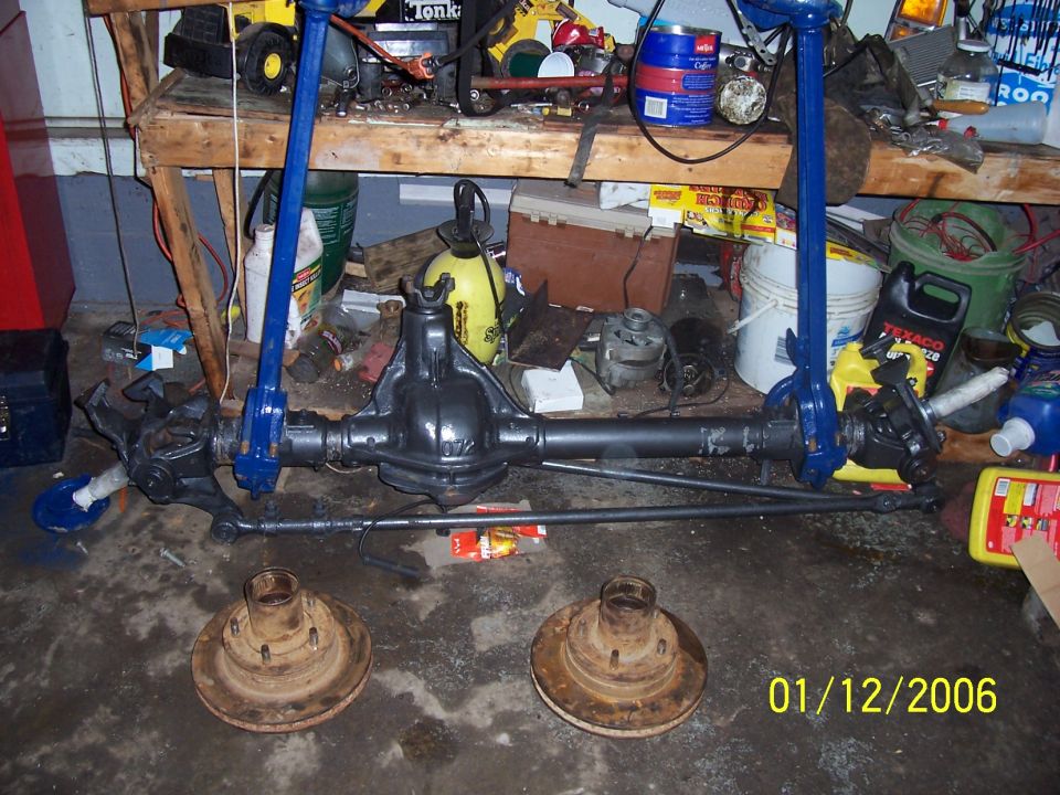 Vehicle axle assembly with brake rotors on the floor