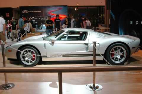 1991 Ford Taurus - A silver Ford GT is showcased at an event, with people in the background.