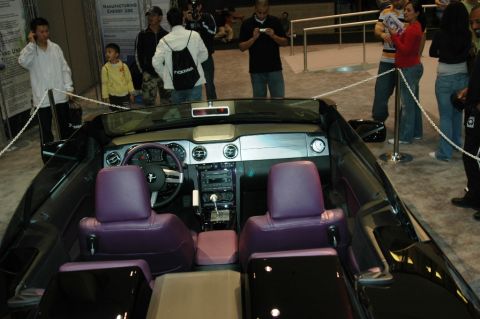 1991 Ford Taurus - Interior of a black convertible with distinctive purple upholstery and dashboard details.
