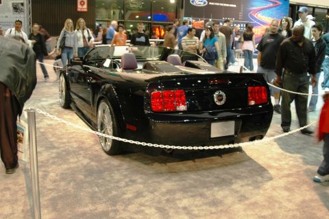 1991 Ford Taurus - Rear view of a black convertible with a GT badge, likely a Ford Mustang from the mid-2000s.