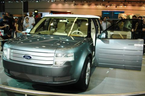 1991 Ford Taurus - A concept SUV is displayed with its driver's side door open, revealing its interior.