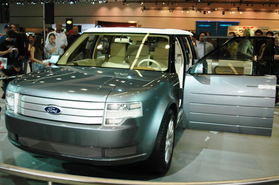 Ford concept SUV with open driver's door, front grille with horizontal bars and Ford logo