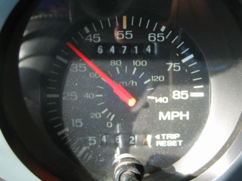 1990 Ford Bronco - close-up of an analog speedometer marked in MPH with a trip-reset feature and an odometer showing 64714 miles.