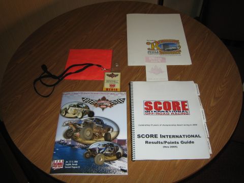 1990 Ford Bronco - photo of SCORE off-road racing programs and credentials, not a vehicle technical document.