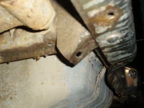 1985 Ford Bronco II - Undercarriage view shows rust and part of the exhaust system.