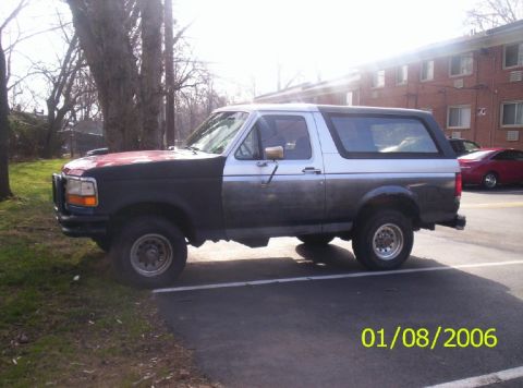 1988 Ford Bronco - This Ford Bronco has a two-tone paint job and appears to be from the early to mid-1990s.