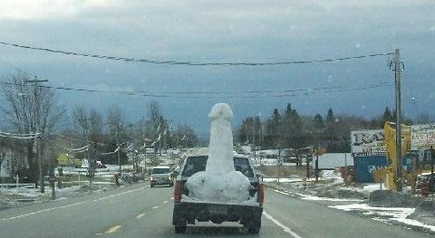 1994 Jeep YJ - A pickup truck transports a large snow sculpture on a winter day.