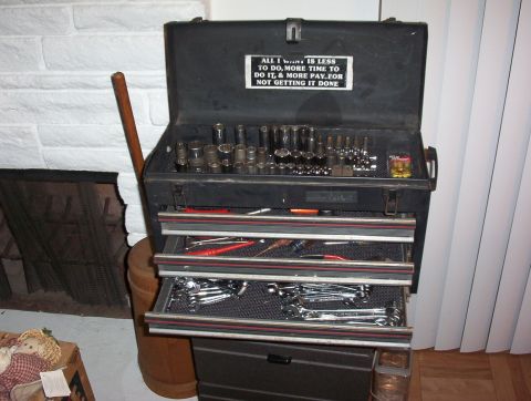1993 Ford Bronco - A black tool chest is open, revealing organized sockets and wrenches. A humorous sticker is affixed to the inside of the lid.