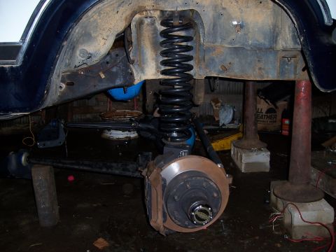 1983 Ford Bronco - Front suspension and axle assembly of a 1983 Ford Bronco, likely undergoing a solid axle swap.