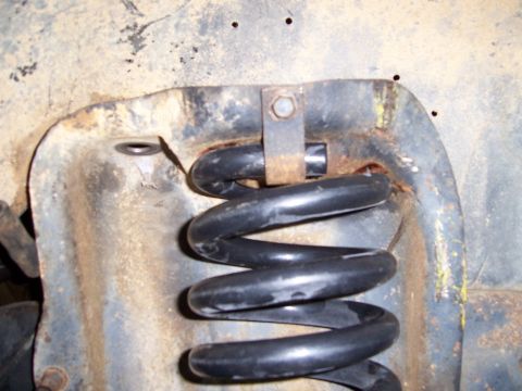 1983 Ford Bronco - A close-up view shows a suspension spring and its mounting hardware.