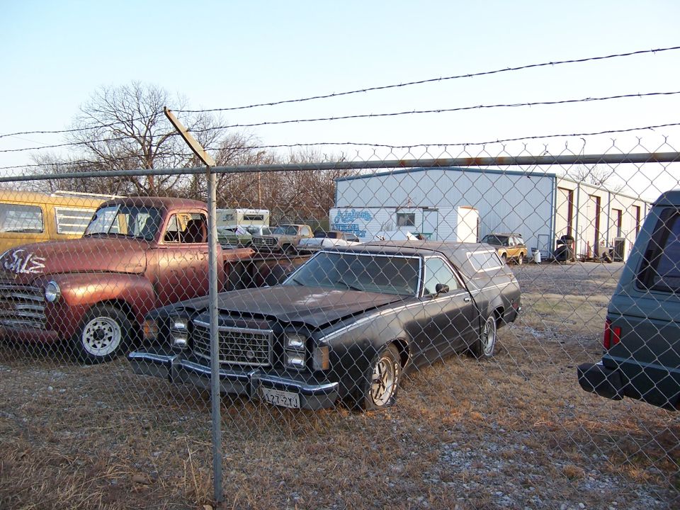 Black 1979 Ford Ranchero with a damaged grille and hood