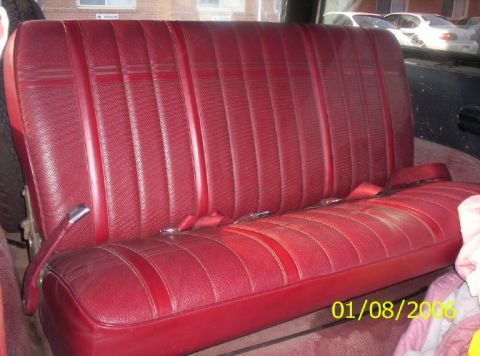 1988 Ford Bronco - Interior view of a red bench seat with visible seatbelts.