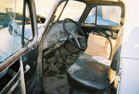 1992 Ford Bronco - Interior view of a vintage truck cab with a cracked windshield and worn seats.