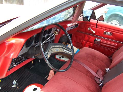 1979 Ford Ranchero - The interior of a 1979 Ford Ranchero shows its red upholstery and dashboard details.