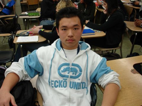 1993 Ford Taurus - A student is seated at a desk in a classroom, wearing a branded hoodie.