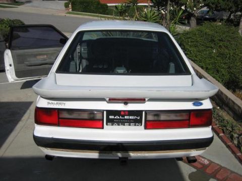 1993 Ford Taurus - Rear view of a white 1993 Saleen Mustang, showing its distinctive spoiler and Saleen badging.