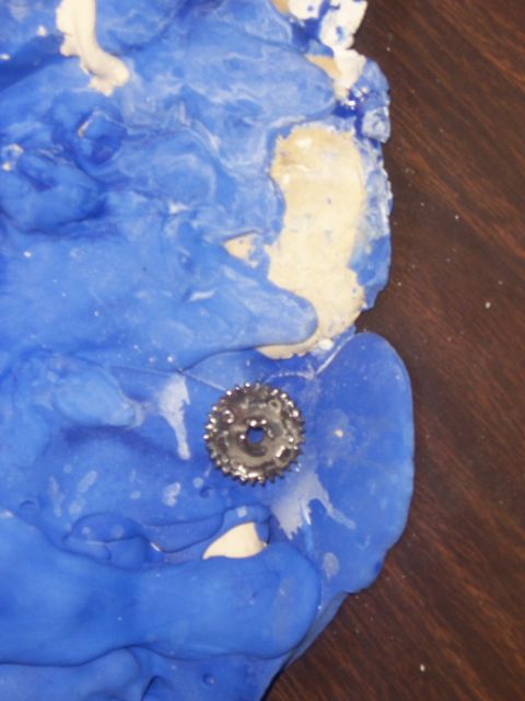 1999 Jeep TJ - A close-up view shows a small metal gear piece within a blue molding substance.