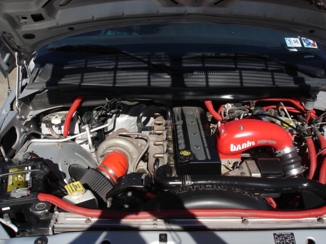 Engine bay with red Banks intake components and turbocharger