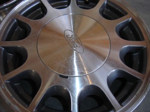 1999 Ford Taurus - A close-up view of a single Ford wheel, showing its design and the brand's emblem.
