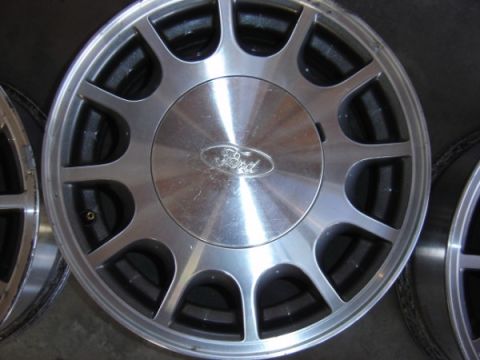 1999 Ford Taurus - Close-up of a Ford wheel with the oval Ford logo visible on the center cap.