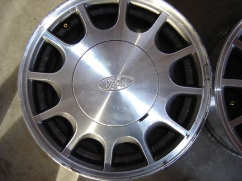1999 Ford Taurus - Close-up of a single Ford alloy wheel with a visible Ford logo in the center.
