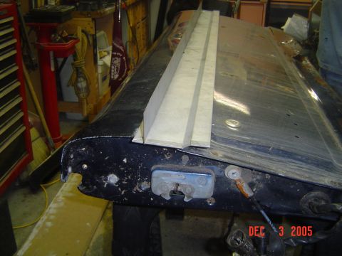 1993 Ford Bronco - Tailgate latch mechanism shown with added wooden trim, likely for repair or modification.