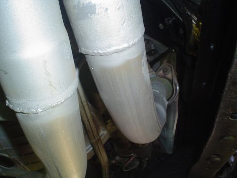 2005 Ford Excursion - Close-up view of vehicle exhaust pipes, revealing their construction and condition.