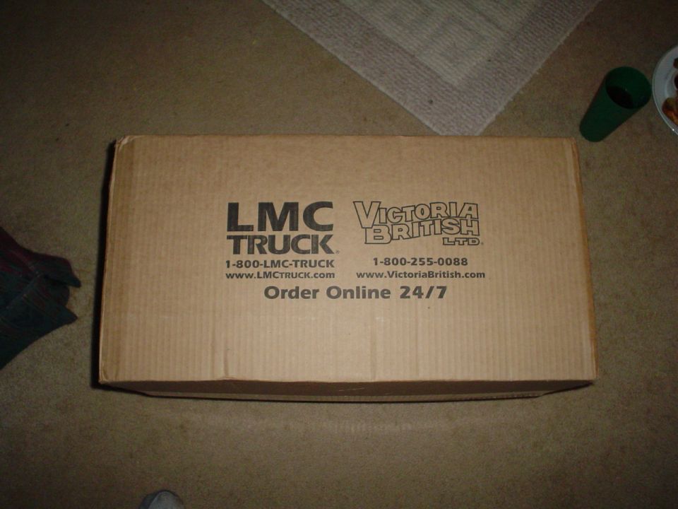 Cardboard box with LMC Truck and Victoria British Ltd. logos, phone numbers, and website addresses