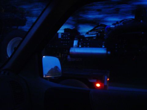 1966 International School Bus - A truck and trailer are visible at night, seen from the interior of another vehicle.