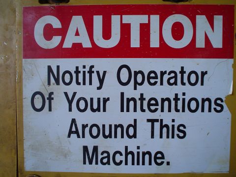 1966 International School Bus - A caution sign provides important safety instructions for operating machinery.