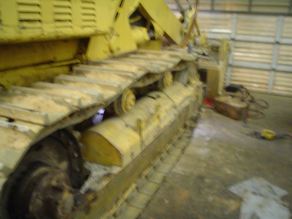 crawler tractor tracks and undercarriage in a garage
