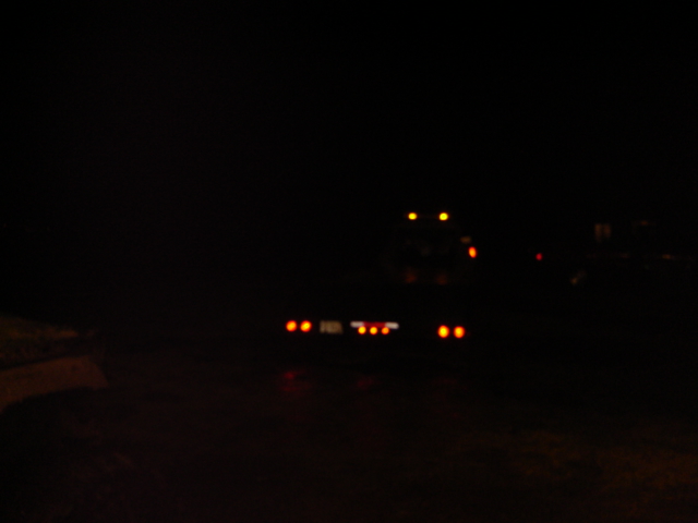 truck with trailer lights on at night