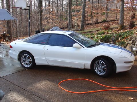 1993 Ford Probe - Side view of a white 1993 Ford Probe coupe with blue racing stripes.