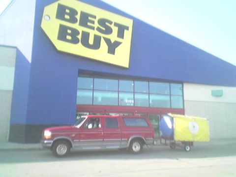 1994 Ford C-150 (Centurion Conversions) - Red pickup truck and trailer parked outside a Best Buy store.