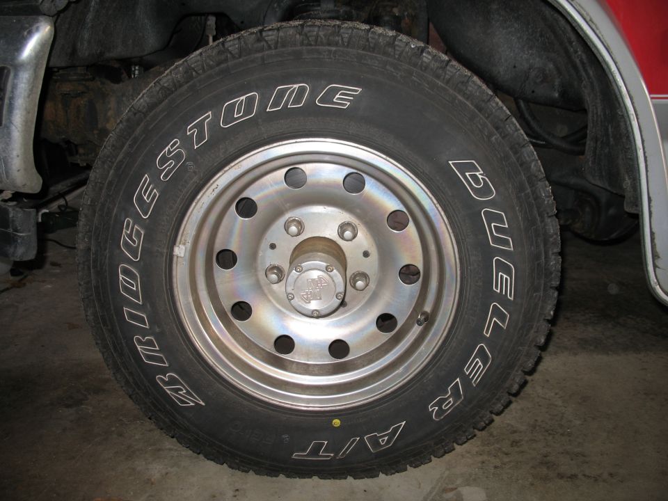 Bridgestone Dueler A/T tire on polished aluminum modular wheel, close-up