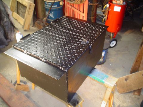 1966 International School Bus - A freshly painted metal toolbox sits on sawhorses in a workshop setting.