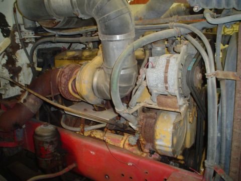 1966 International School Bus - Close-up view of a vehicle's engine, showing various components and a red chassis.