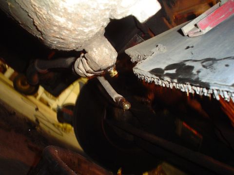 1966 International School Bus - A close-up view of a vehicle's undercarriage reveals a fuel line and a tire, with visible rust and fluid leaks.