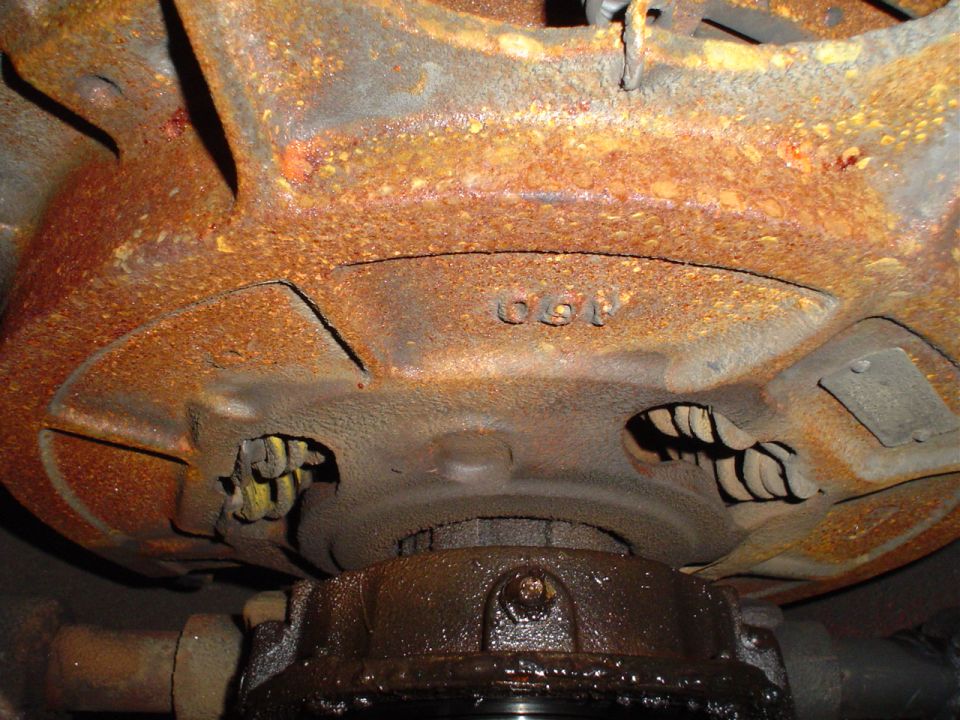 Rusted undercarriage part with visible numbers '691'