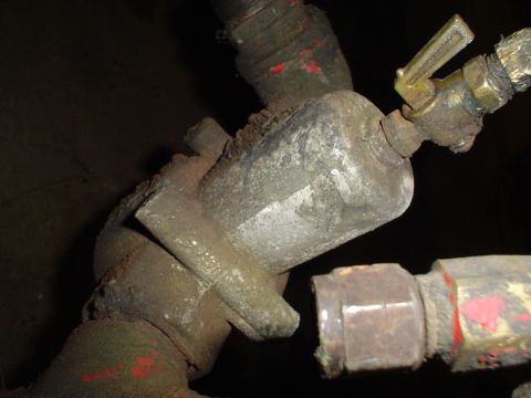 1966 International School Bus - This image shows a close-up of a vehicle's fuel filter housing and associated plumbing.