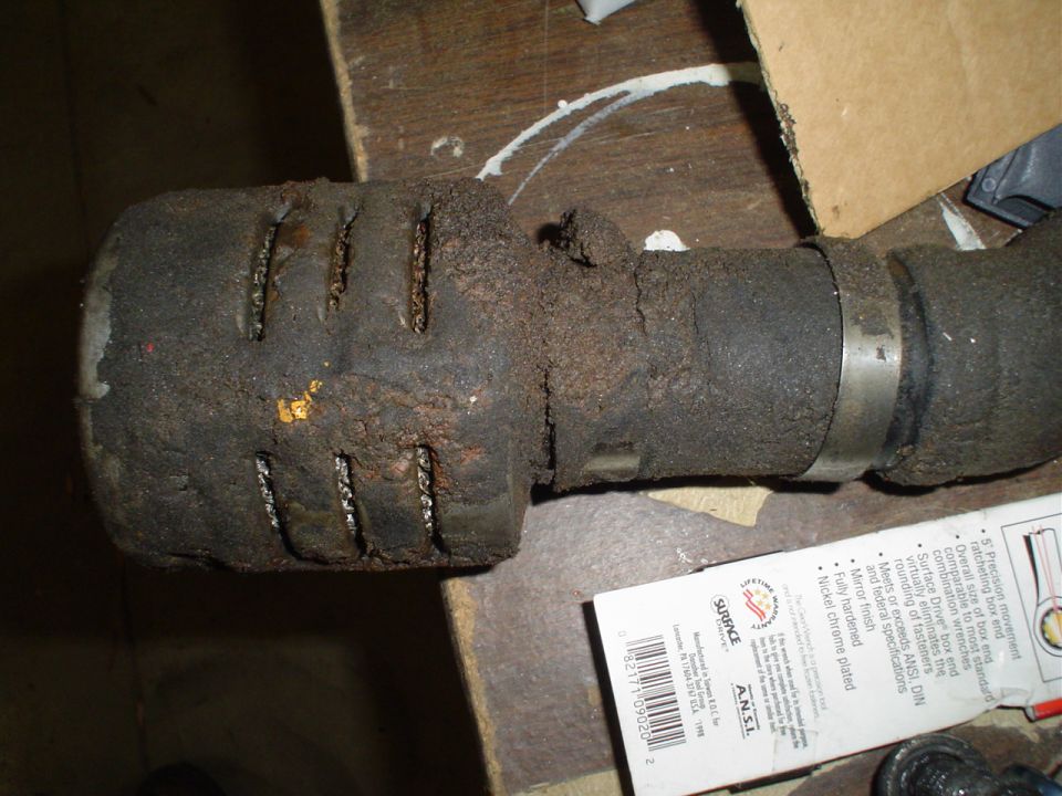 Exhaust pipe with a dirty air filter and a metal clamp. Packaging visible