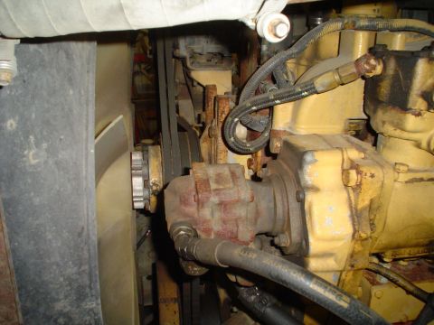 1966 International School Bus - A view of the engine compartment, showing belts, a fan, and various engine components.